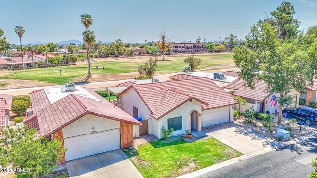 a aerial view of a house with garden space and a patio