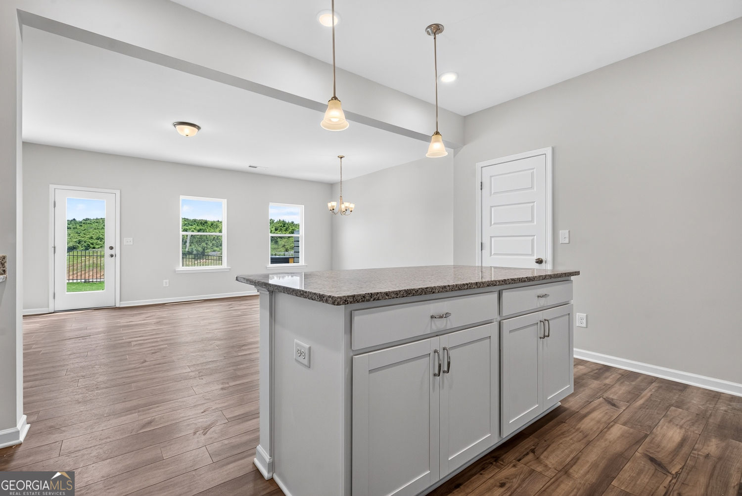 155 Oconee Road, Unit 252 Cartersville, GA 30120 - Photo 17 of 39 a hall with kitchen island white cabinets and wooden floor