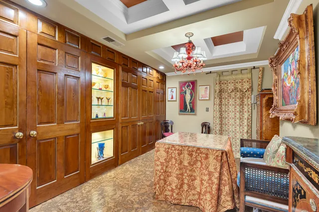 a bedroom with furniture and a large window