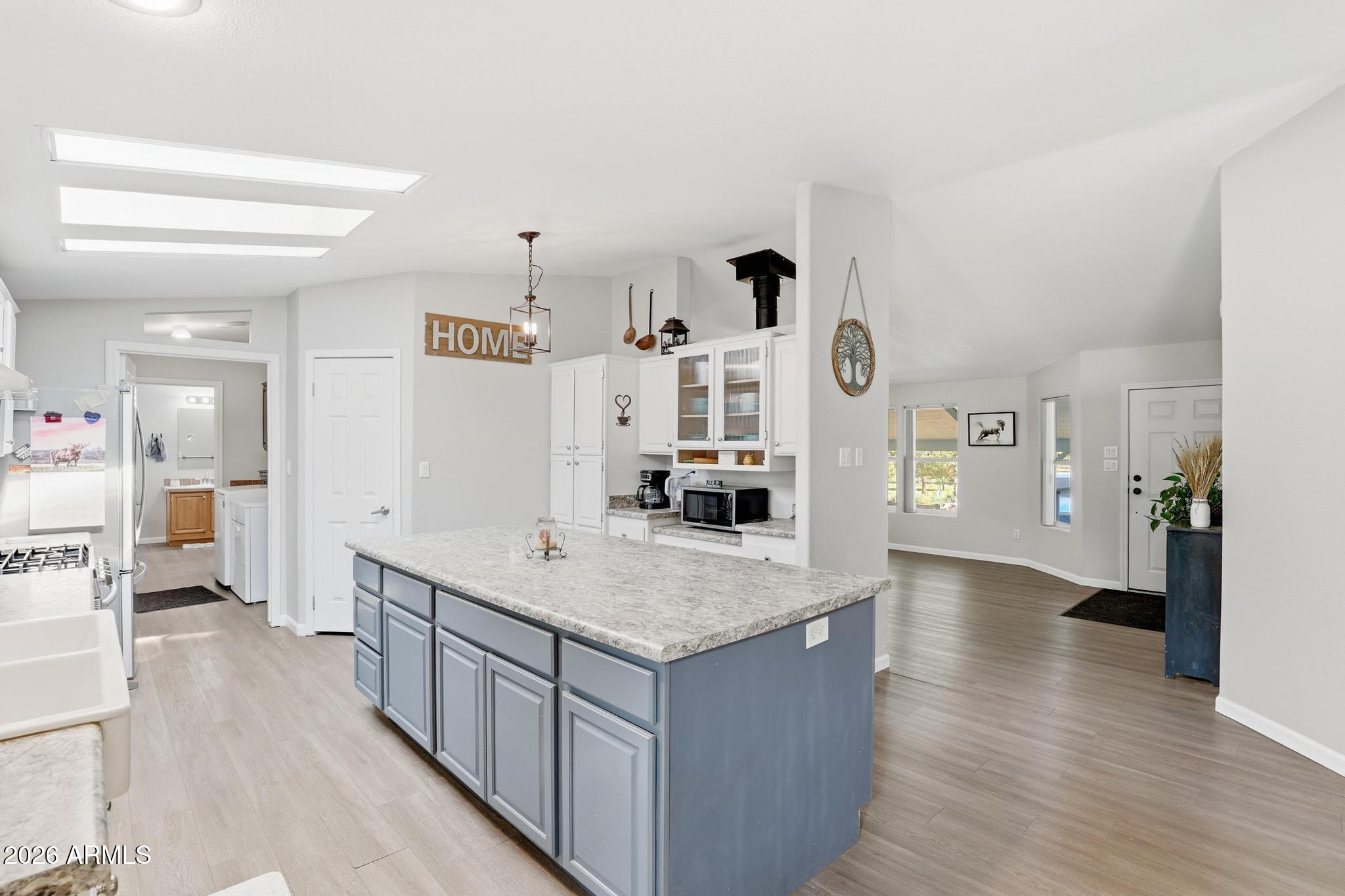 191 Cornerstone Way Payson, AZ 85541 - Photo 10 of 37 a living room with stainless steel appliances kitchen island a large counter top and a wooden floor