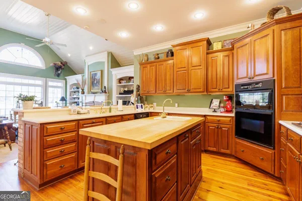 a kitchen with stainless steel appliances granite countertop a sink and a stove