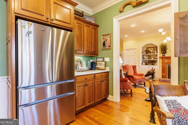a view of a dining room with furniture a chandelier and wooden floor