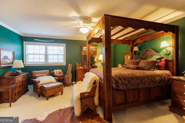 a spacious bedroom with bed and a chandelier