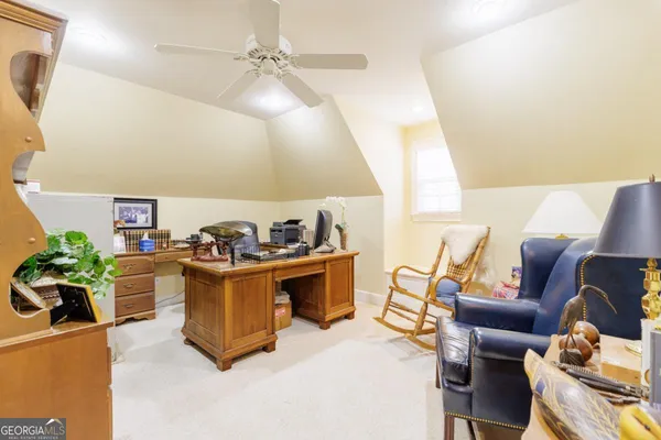 a view of a balcony with chairs and floor to ceiling window