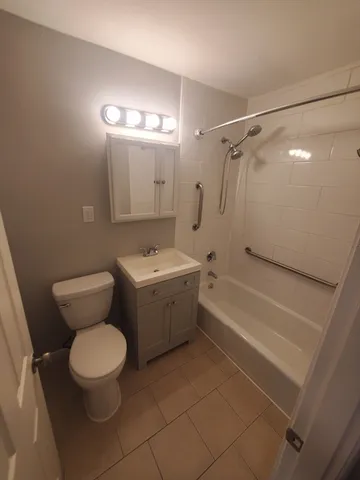 a bathroom with a toilet a sink and bathtub