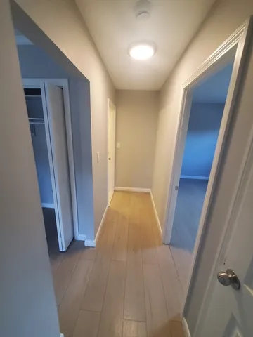 a view of hallway with wooden floor