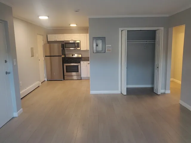 a view of kitchen with refrigerator and window