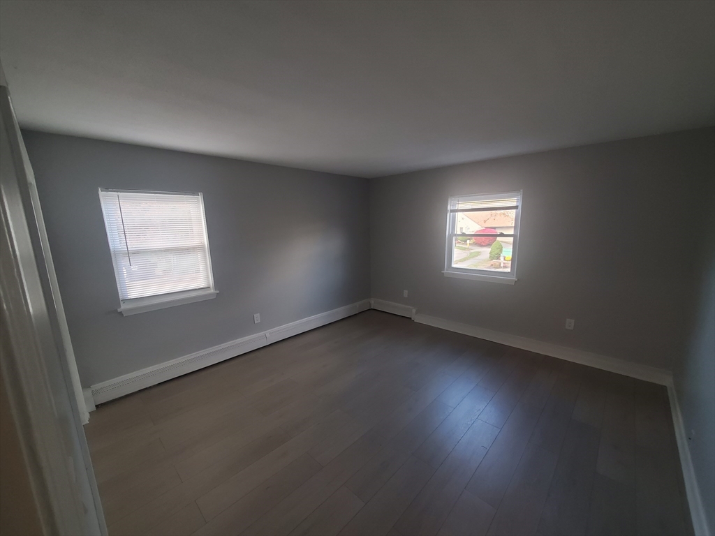 215 Pearl Street, Unit 8 Stoughton, MA 02072 - Photo 6 of 18 an empty room with a window