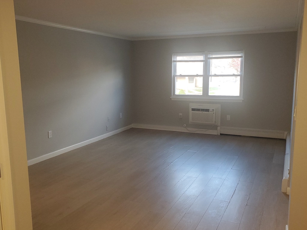 215 Pearl Street, Unit 8 Stoughton, MA 02072 - Photo 7 of 18 an empty room with a window