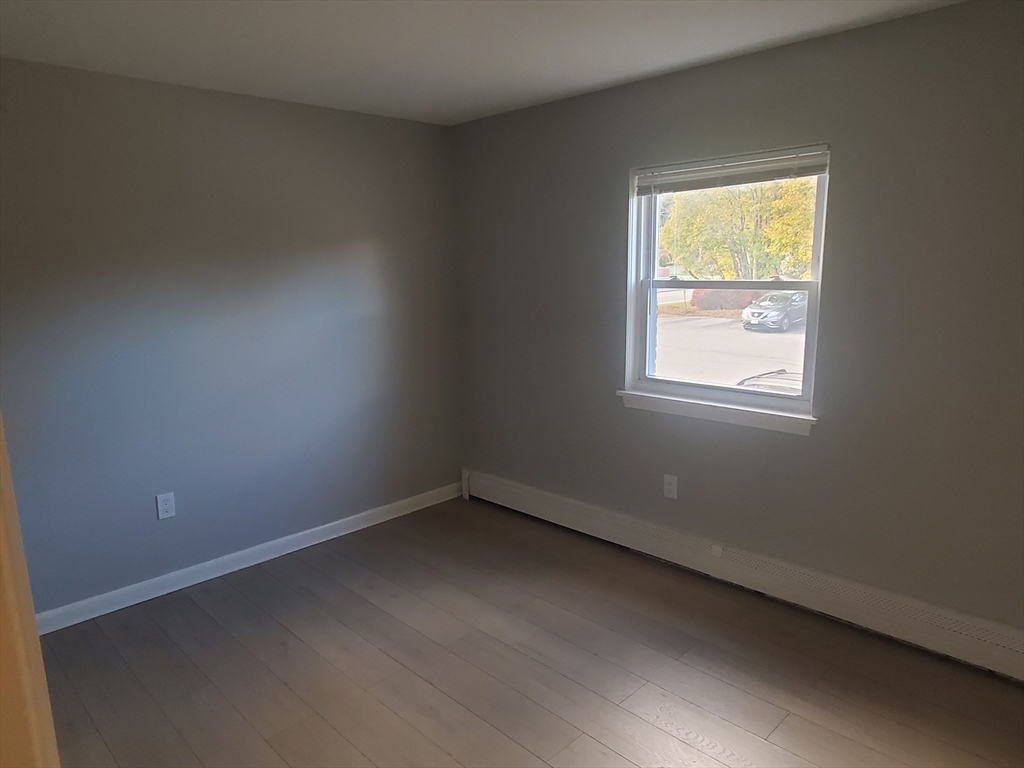 215 Pearl Street, Unit 8 Stoughton, MA 02072 - Photo 10 of 18 an empty room with a window