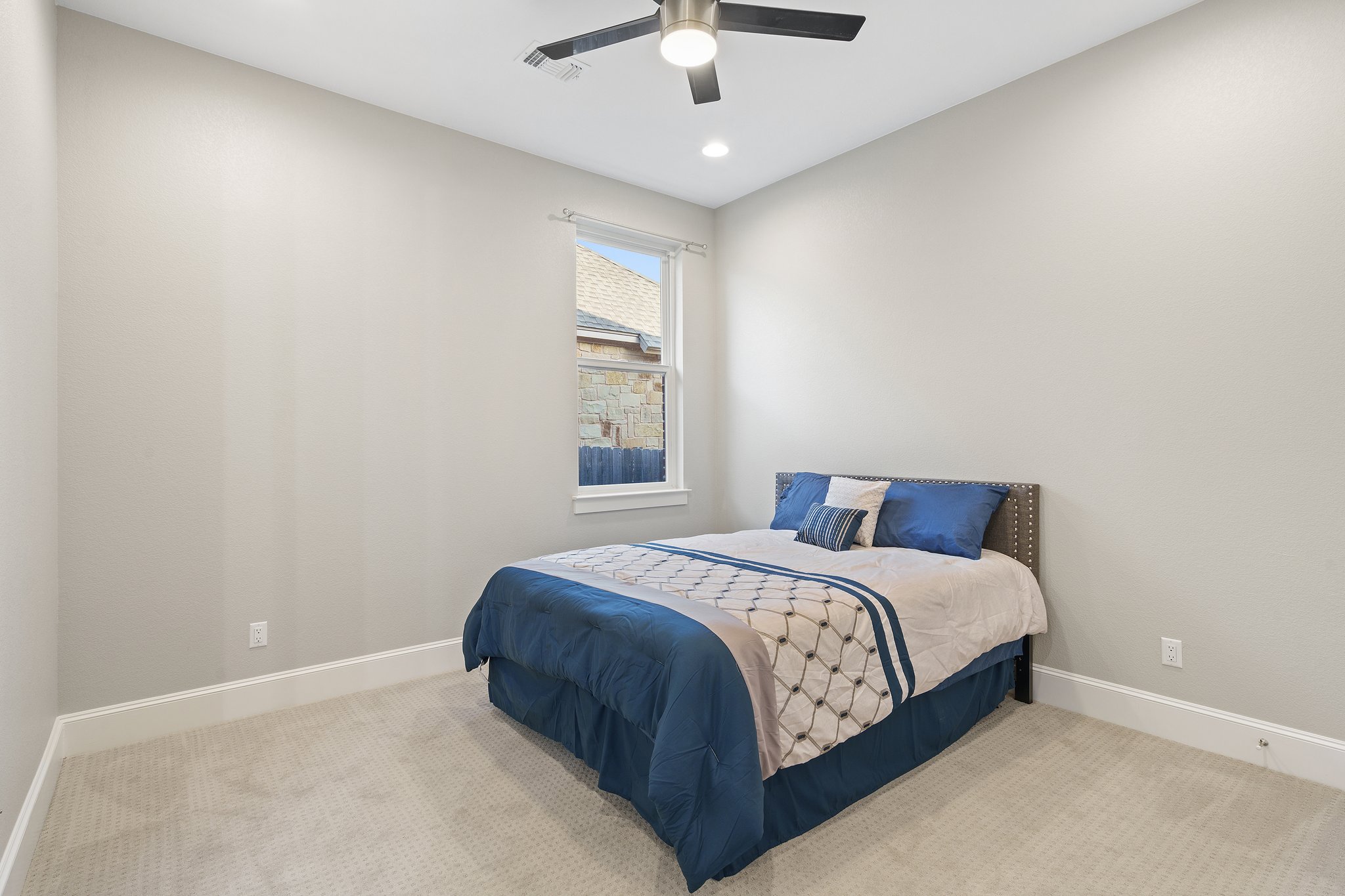 112 Axis Loop Georgetown, TX 78628 - Photo 33 of 39 a bedroom with a bed and a ceiling fan
