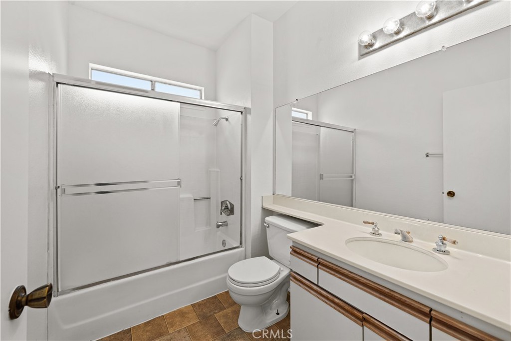 27645 Susan Beth Way, Unit A Saugus, CA 91350 - Photo 20 of 26 a bathroom with a sink a toilet and shower
