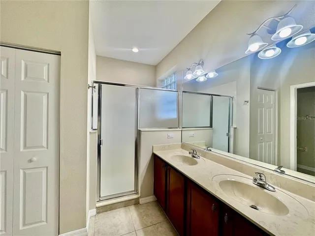 a bathroom with a double vanity sink and a mirror