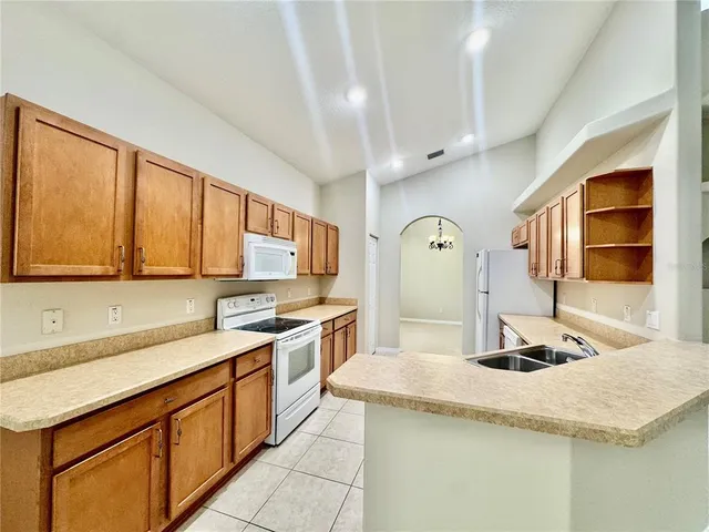 a kitchen with stainless steel appliances granite countertop a sink dishwasher and cabinets with wooden floor