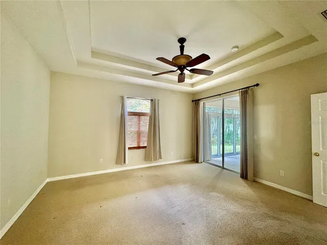 a view of an empty room with a ceiling fan