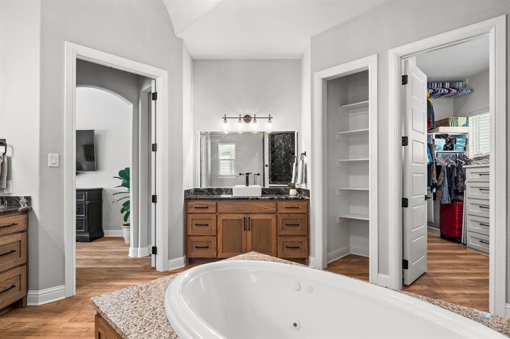 Tbd Tbd Anchor Point Quinlan, TX 75474 - Photo 16 of 40 a spacious bathroom with a granite countertop sink and a mirror