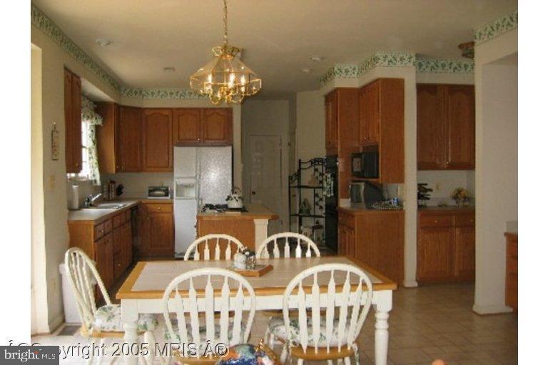 6397 True Lane Springfield, VA 22150 - Photo 4 of 6 a view of a dining room with furniture and chandelier