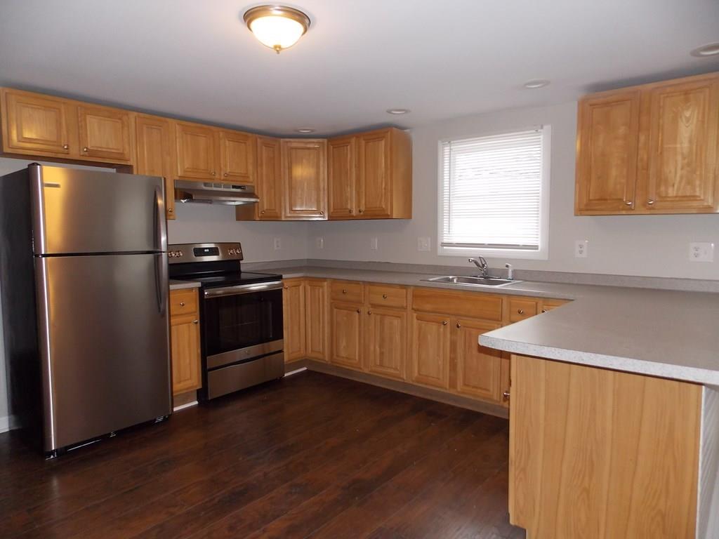 4 Austin Road Phillipston, MA 01331 - Photo 4 of 15 a kitchen with wooden cabinets and white appliances