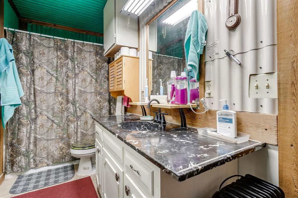 436 Luke Road Springtown, TX 76082 - Photo 24 of 39 Bathroom featuring vanity and curtained shower