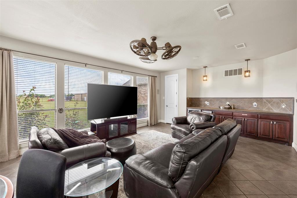 219 Mohundro Road Ferris, TX 75125 - Photo 11 of 40 a living room with furniture and a flat screen tv