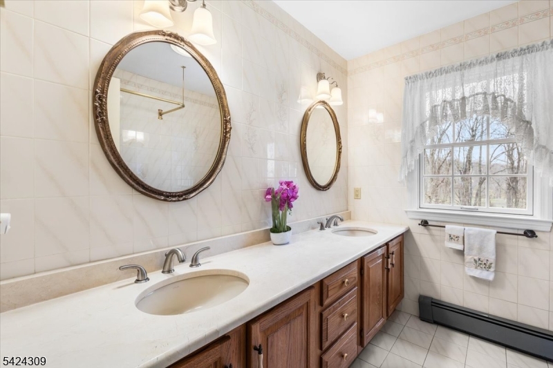 58 Andover Road Sparta, NJ 07871 - Photo 25 of 38 a bathroom with a sink and a mirror