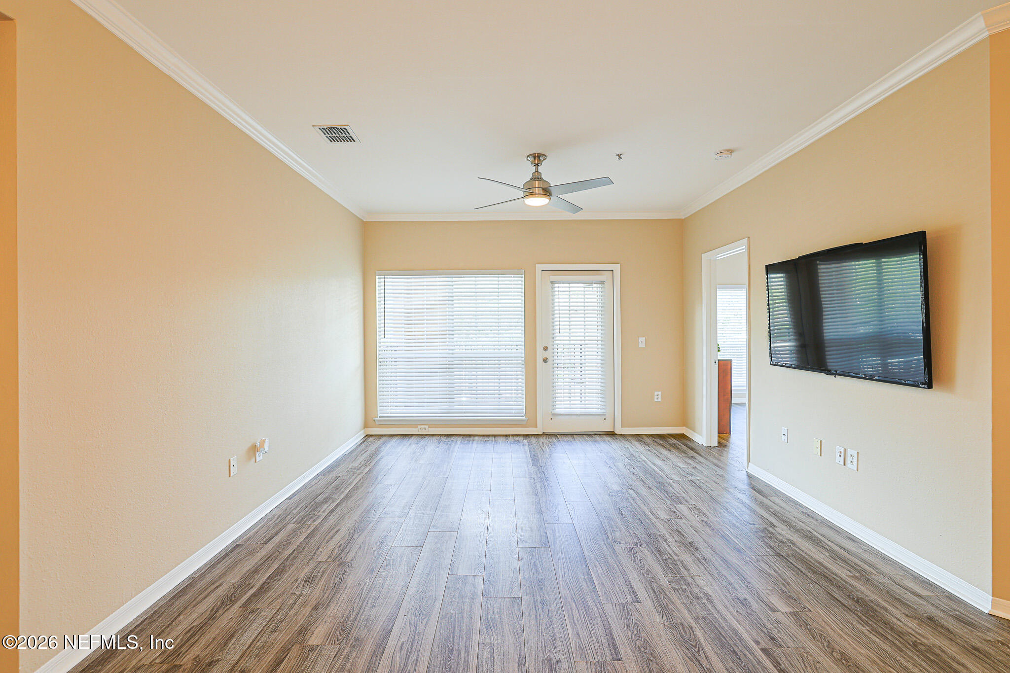 10961 Burnt Mill Road, Unit 426 Jacksonville, FL 32256 - Photo 10 of 24 a view of an empty room with window and wooden floor