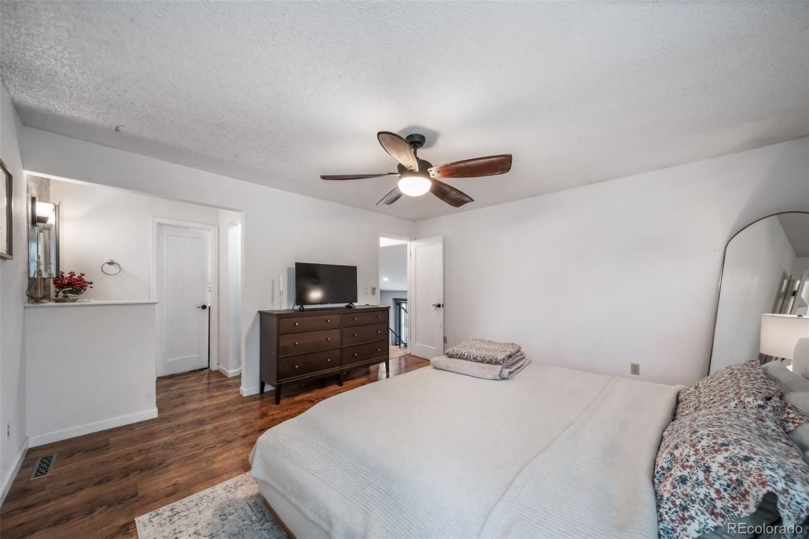 17372 East Prentice Circle Centennial, CO 80015 - Photo 15 of 41 a bedroom with a bed and a flat screen tv