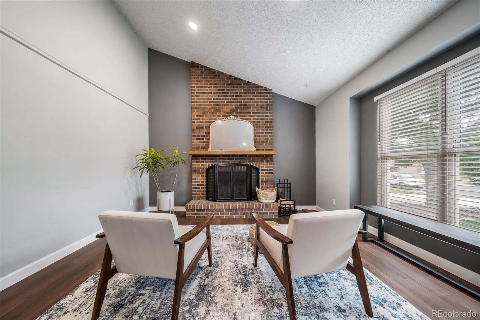 17372 East Prentice Circle Centennial, CO 80015 - Photo 4 of 41 a living room with furniture a fireplace and a potted plant