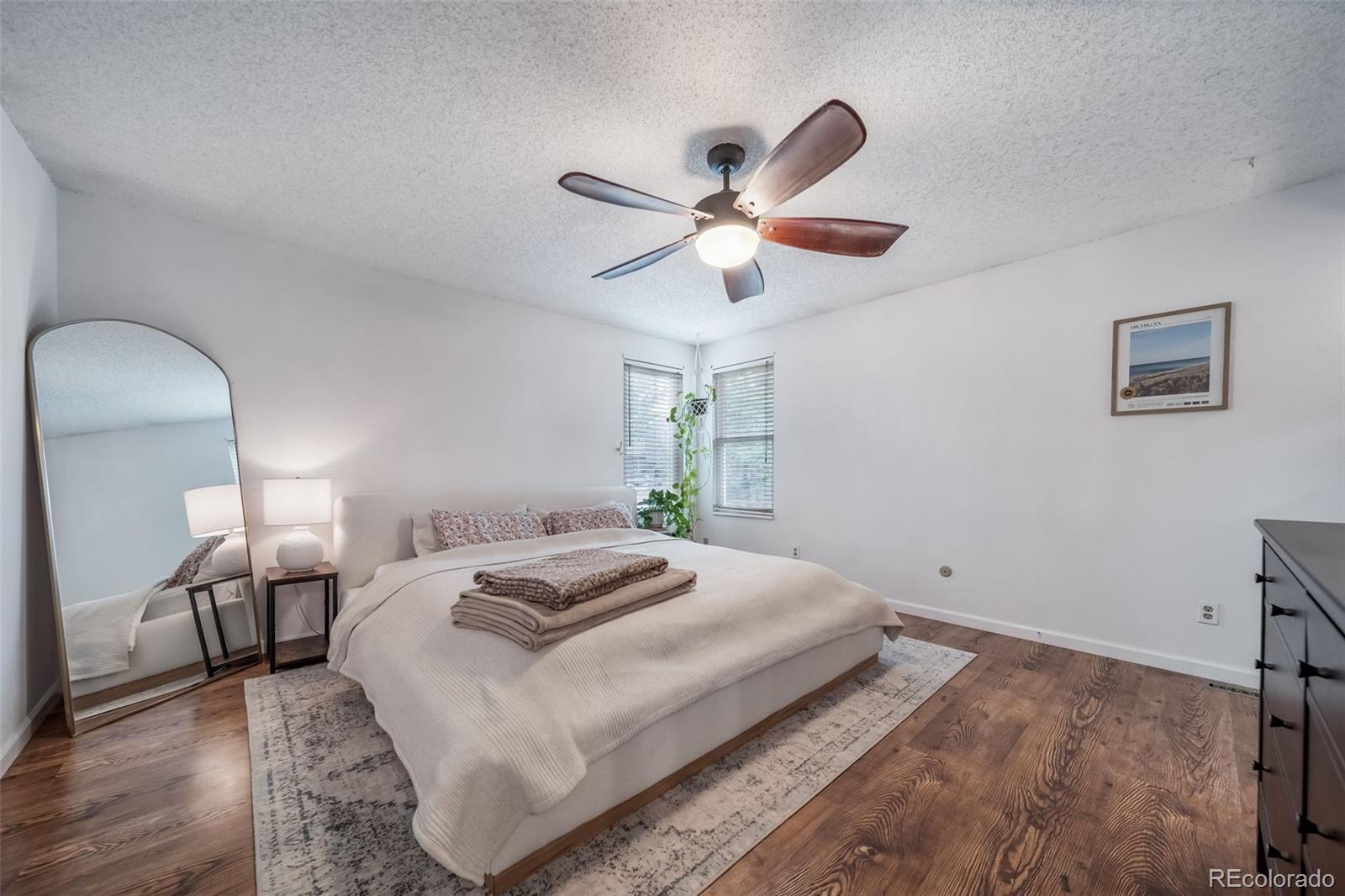 17372 East Prentice Circle Centennial, CO 80015 - Photo 6 of 41 a bedroom with a bed and a chandelier