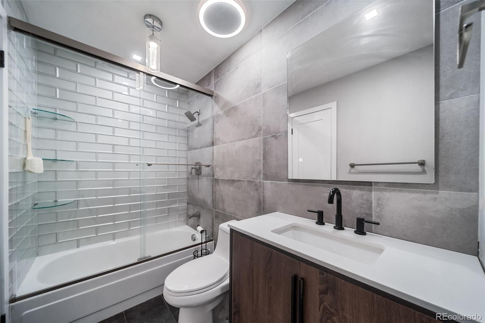 17372 East Prentice Circle Centennial, CO 80015 - Photo 9 of 41 a bathroom with a granite countertop sink toilet and shower