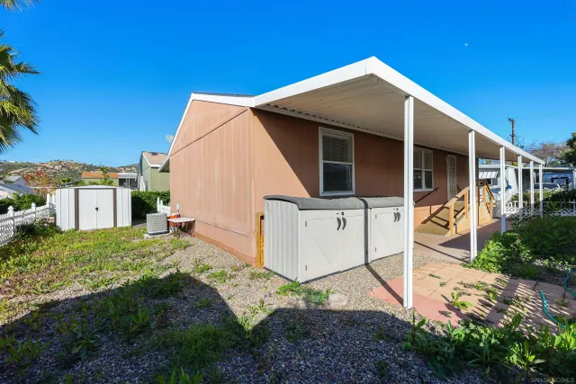 a backyard of a house with table and chairs