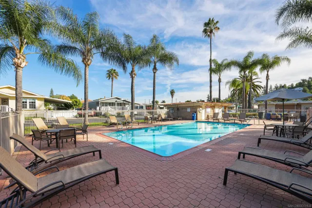 a swimming pool with outdoor seating