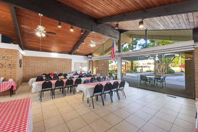 a view of a porch with dining table and chairs