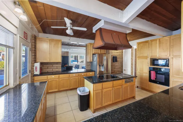 a large white kitchen with a large window
