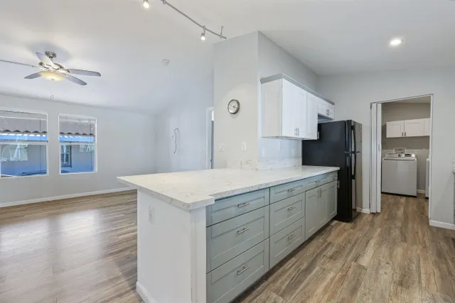 a kitchen with a refrigerator and a sink