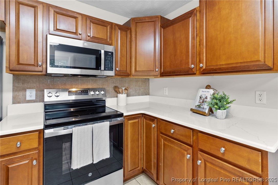 43 Ambrose Point Cameron, NC 28326 - Photo 14 of 45 a kitchen with stainless steel appliances granite countertop a sink stove and microwave