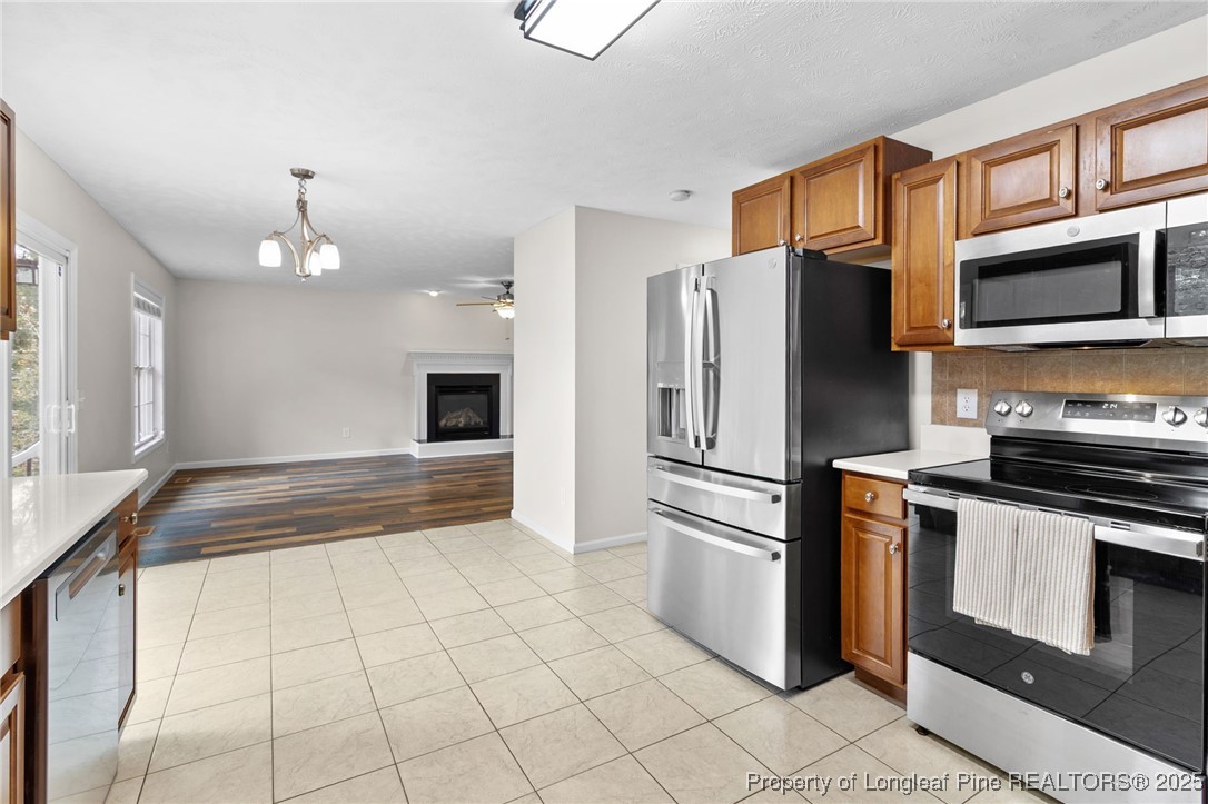 43 Ambrose Point Cameron, NC 28326 - Photo 15 of 45 a kitchen with granite countertop a refrigerator and a stove top oven