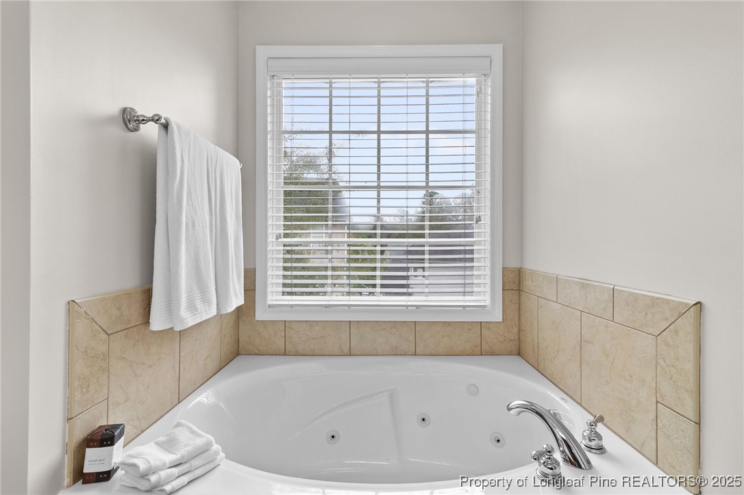 43 Ambrose Point Cameron, NC 28326 - Photo 30 of 45 a bathroom with a bathtub and a window
