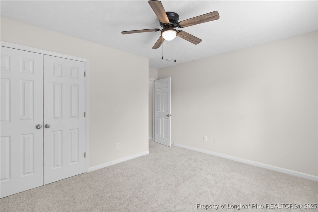 43 Ambrose Point Cameron, NC 28326 - Photo 36 of 45 an empty room with a ceiling fan and a window