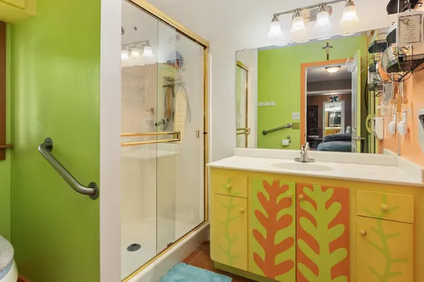 a bathroom with a granite countertop sink and a mirror