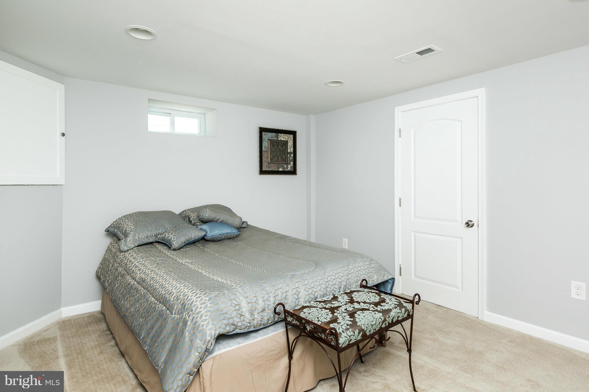 1015 Marksworth Road Catonsville, MD 21228 - Photo 12 of 13 a bedroom with a bed and a table