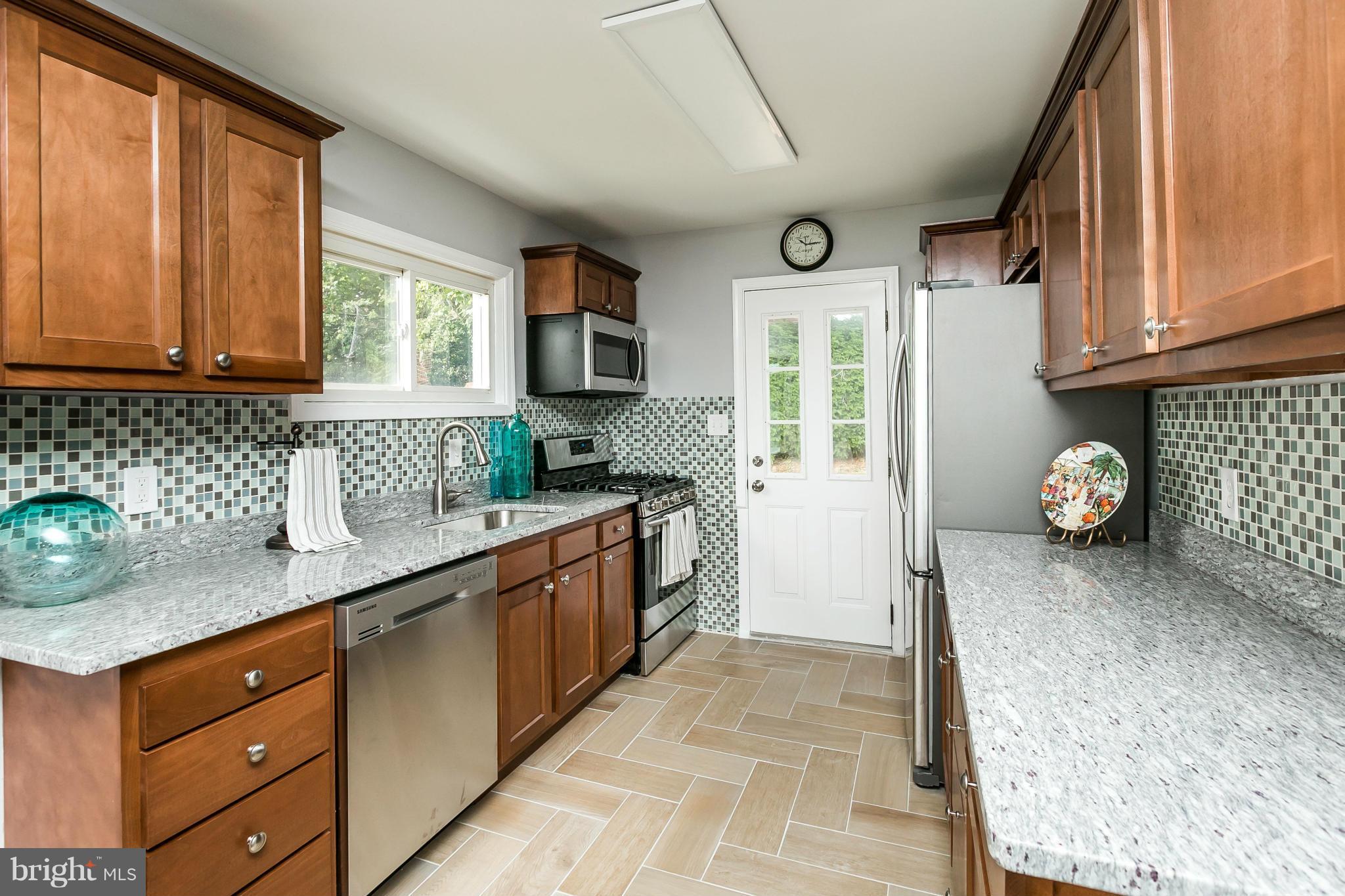 1015 Marksworth Road Catonsville, MD 21228 - Photo 4 of 13 a kitchen with a sink window and cabinets