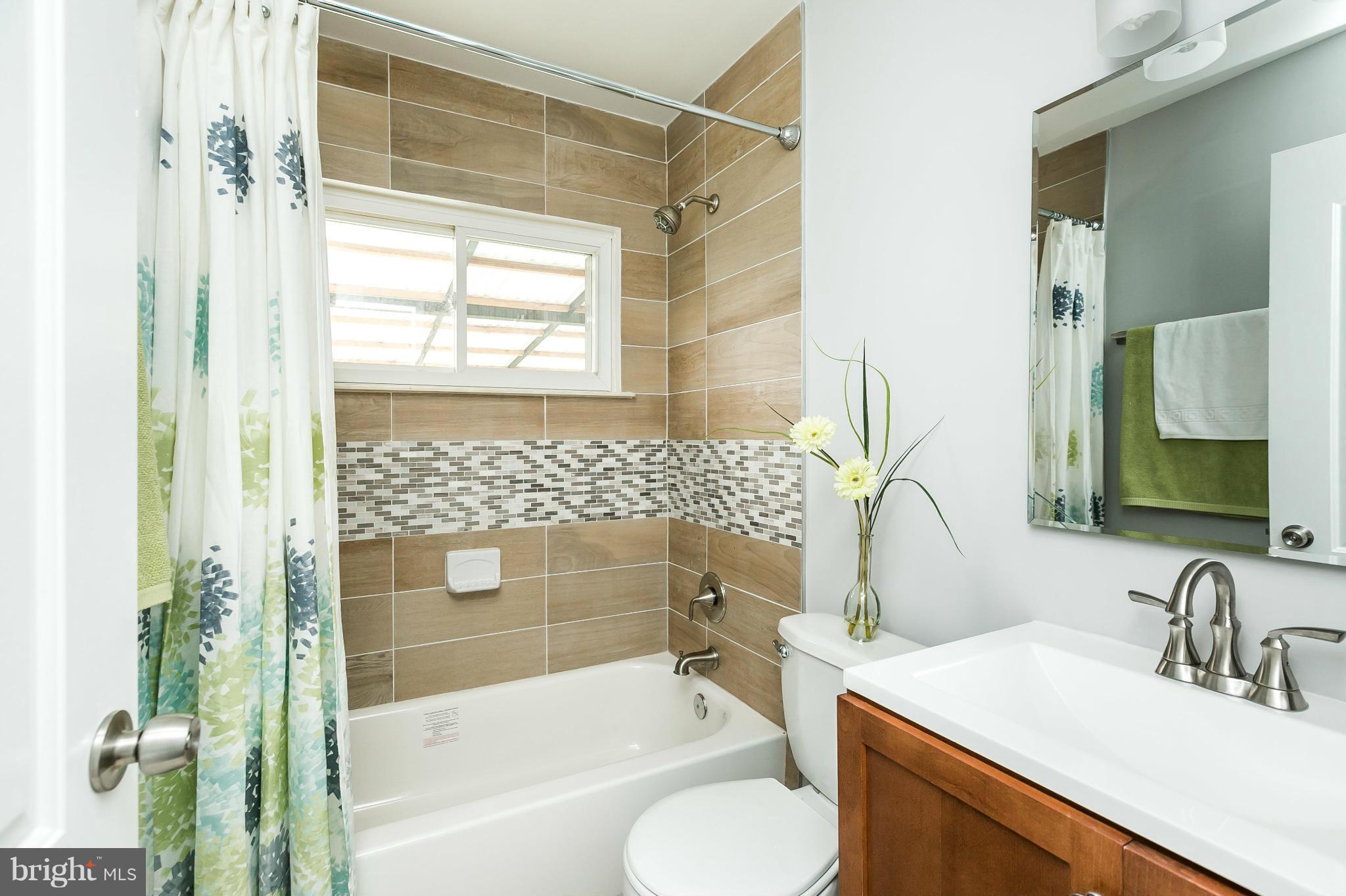 1015 Marksworth Road Catonsville, MD 21228 - Photo 7 of 13 a bathroom with a sink toilet and shower
