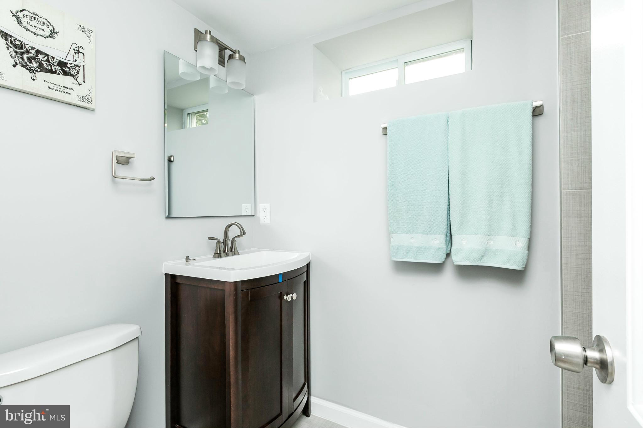 1015 Marksworth Road Catonsville, MD 21228 - Photo 9 of 13 a bathroom with a sink a toilet and shower
