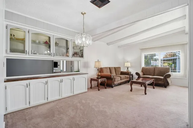a living room with furniture and chandelier