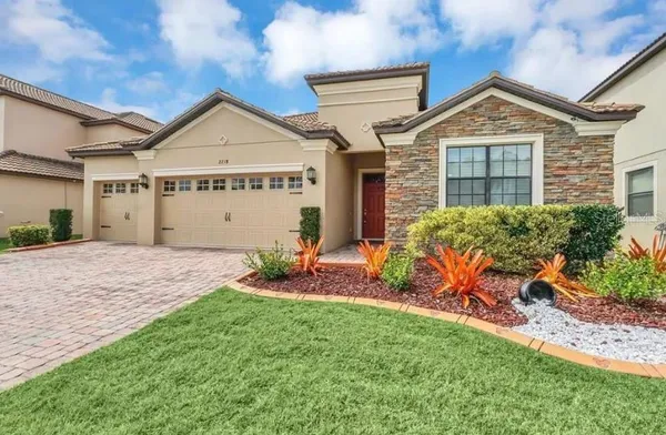 a front view of a house with a yard and garage