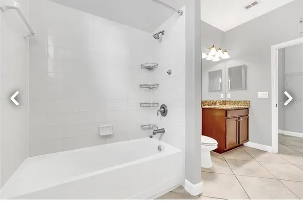 a bathroom with a bathtub sink and mirror