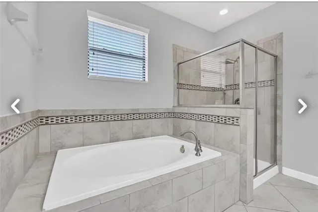 a bathroom with a tub and a shower