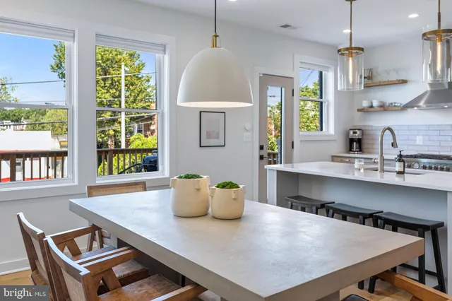 a kitchen with a table chairs and window