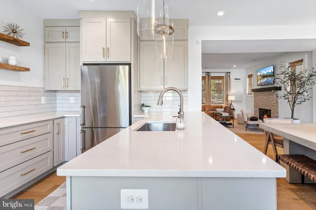 a kitchen with stainless steel appliances granite countertop a stove and a refrigerator